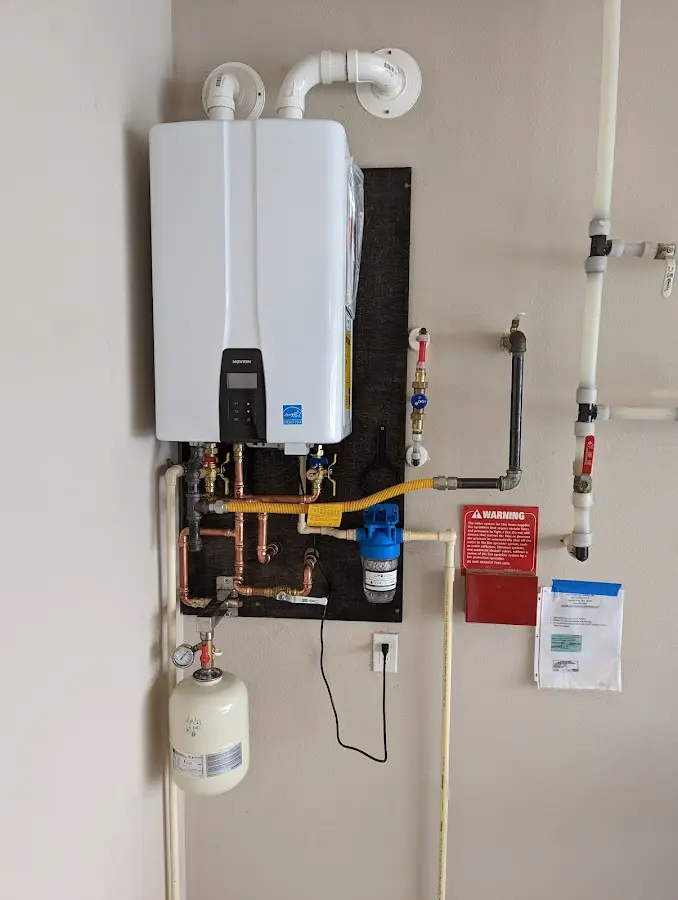 Professional plumber installing copper piping in a Webster home